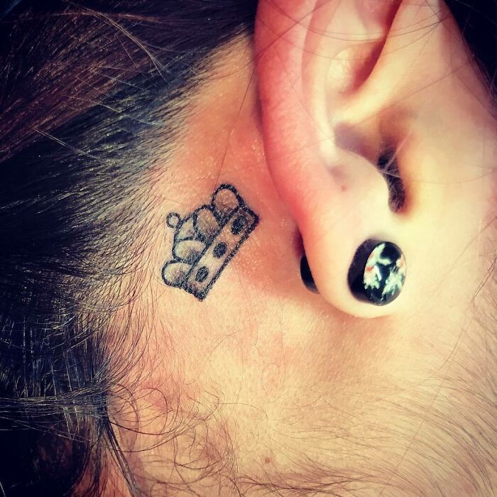 ear tattoo of a crown