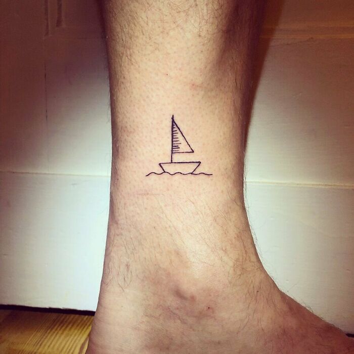 minimalistic tattoo of a sailing boat