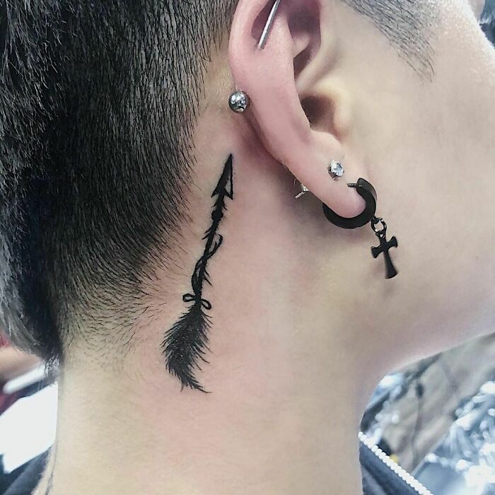 ear tattoo of an arrow