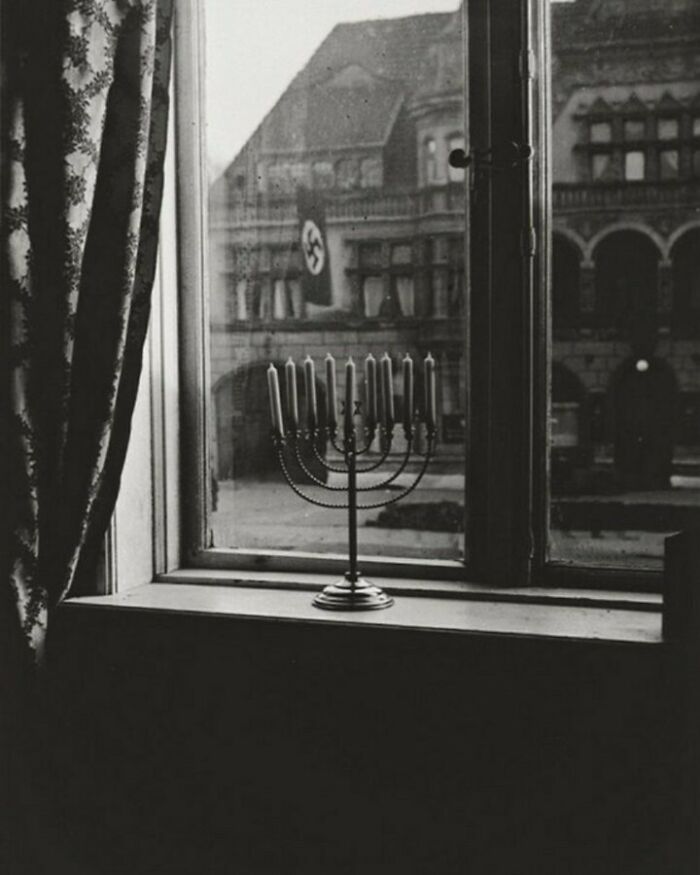 A Jewish candle on a windowsill with a view throught window 
