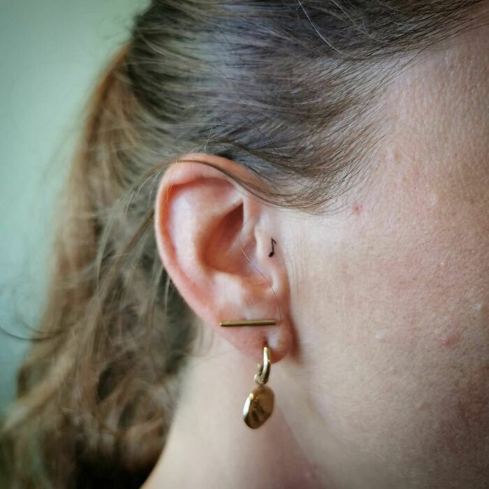 ear tattoo of a single musical note