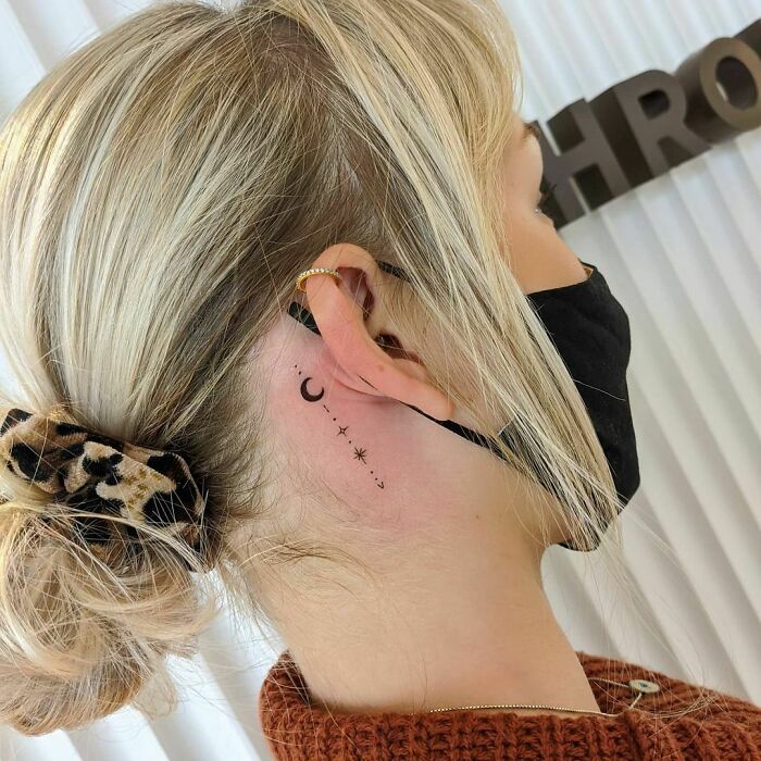ear tattoo of the moon and stars