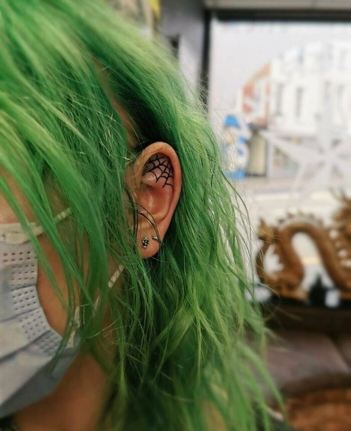 ear tattoo of a cobweb