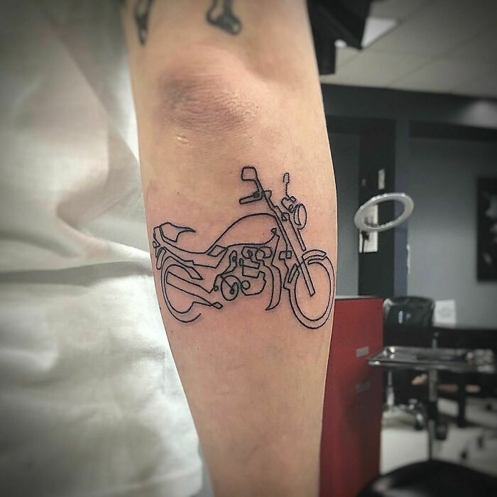 Single line motorbike back arm tattoo