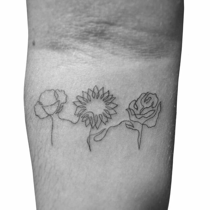 Single line flowers arm tattoo