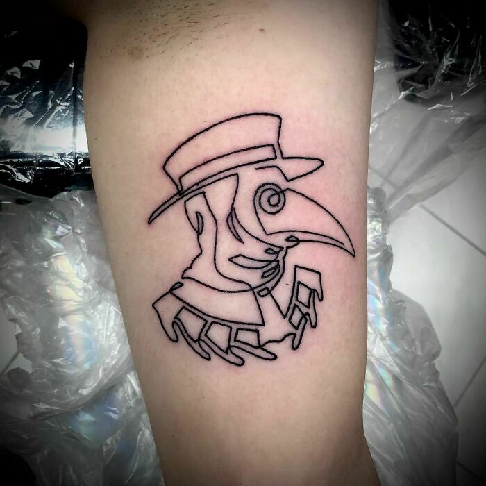 Line plague doctor arm tattoo