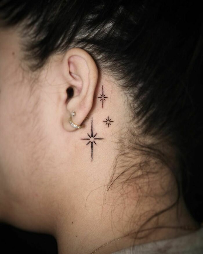 ear tattoo of twinkling stars