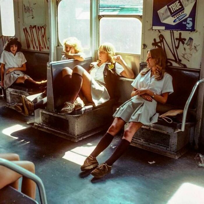 Multiple young women sitting in a New York City’s Subway 