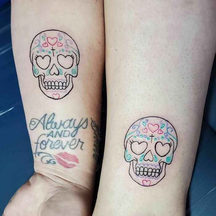 Two best friend tattoos featuring colorful sugar skulls and text "Always and forever" with a red lipstick kiss mark.