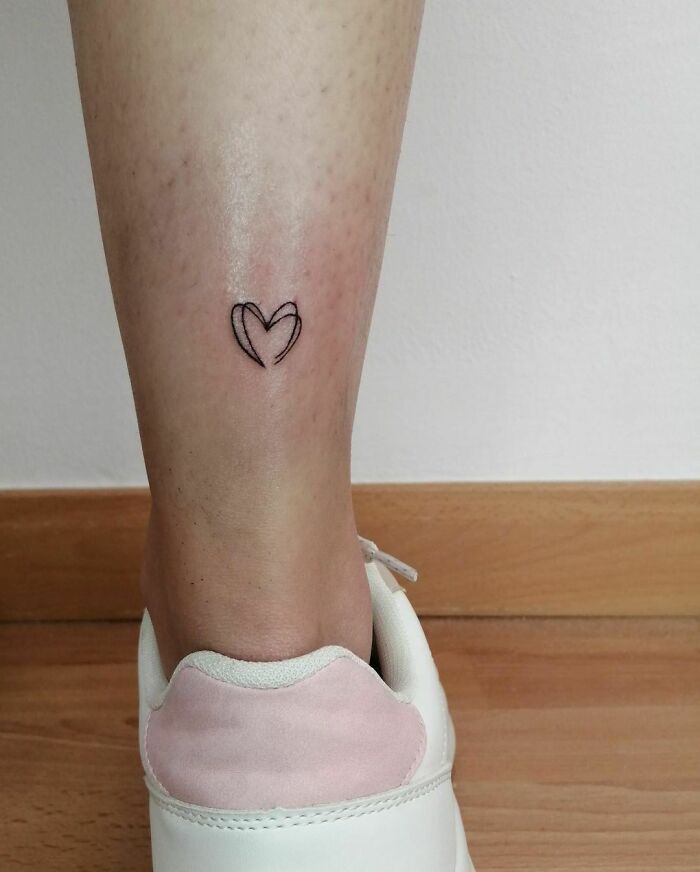 Single line mini heart leg tattoo