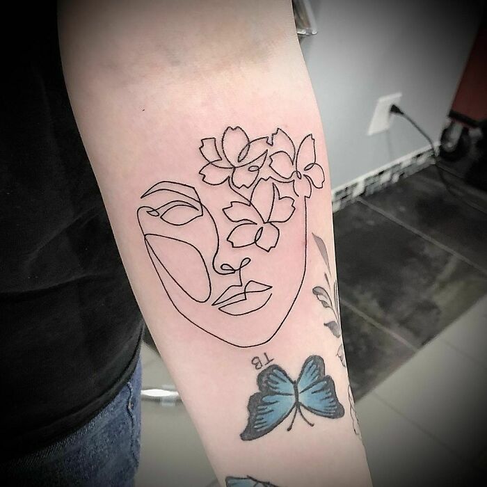 Single line floral lady arm tattoo