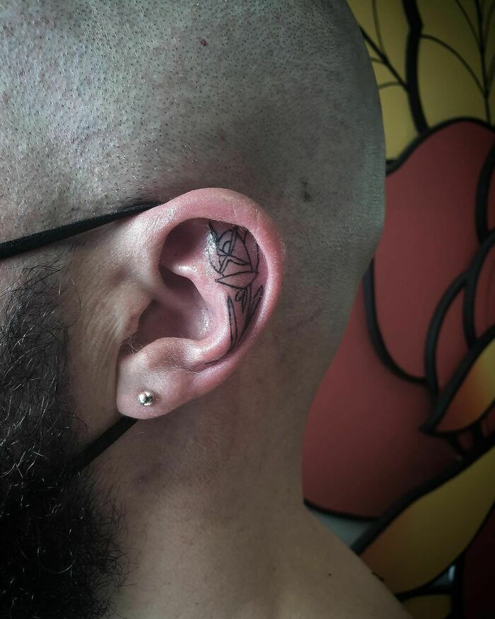 ear tattoo of a sharp corner design rose