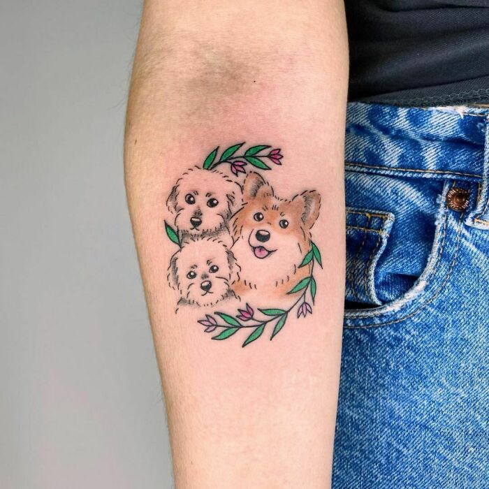Dogs and flowers arm tattoo