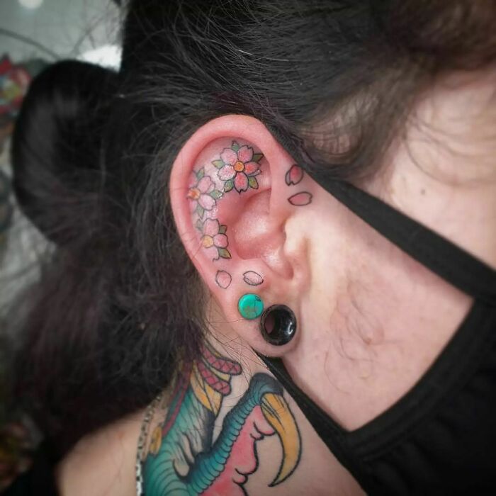 ear tattoo of cherry blossoms