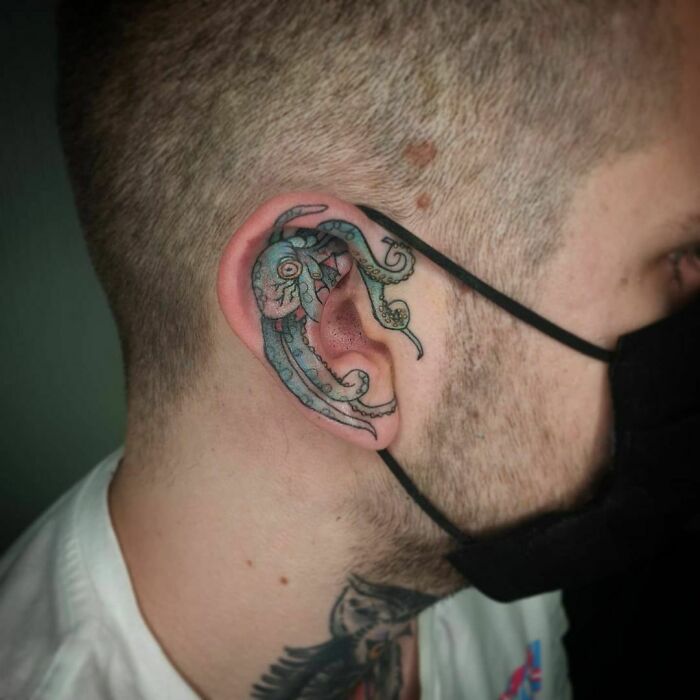 Octopus ear tattoo design blending intricate details in subtle colors.