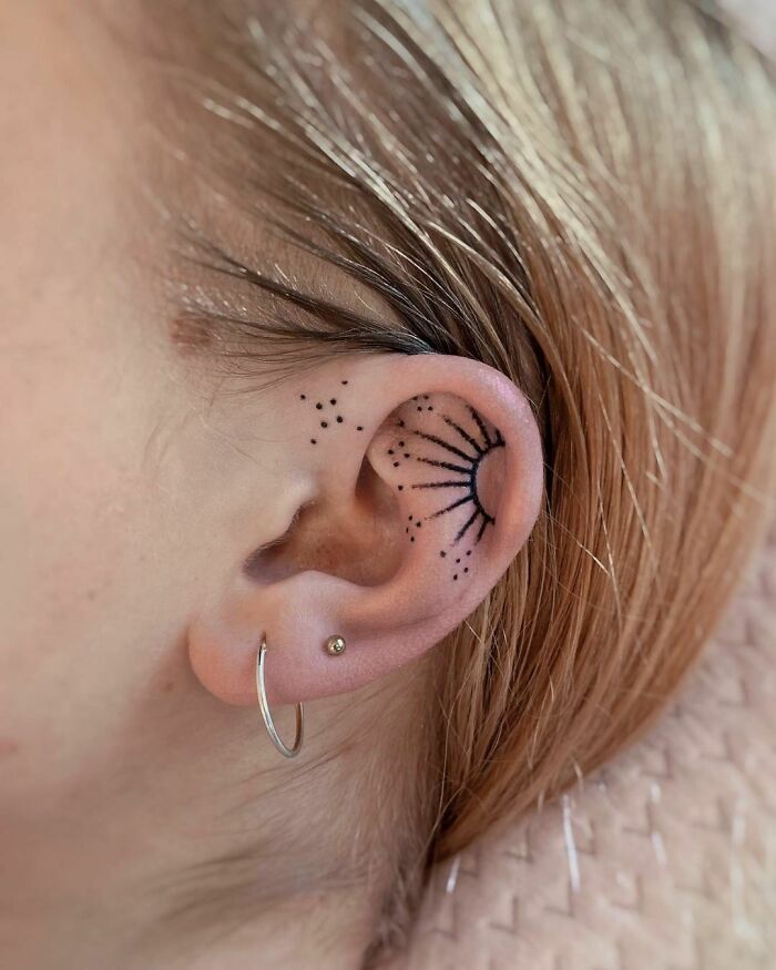 ear tattoo of the sun