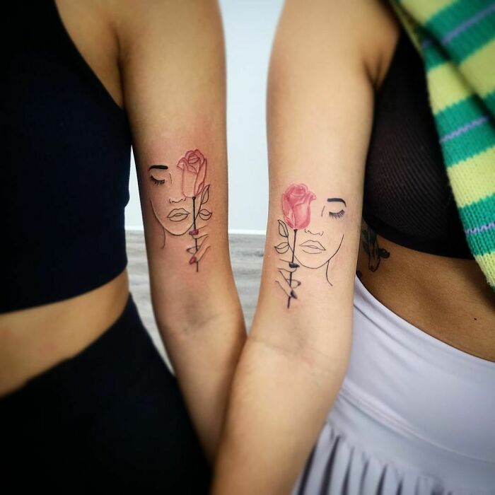 Matching lady face with rose arm tattoos