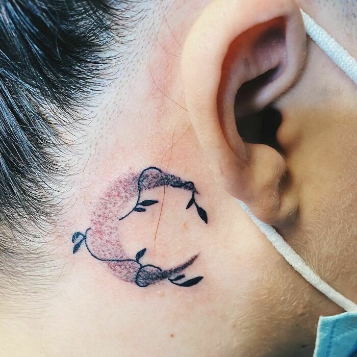 ear tattoo of the moon and leaves