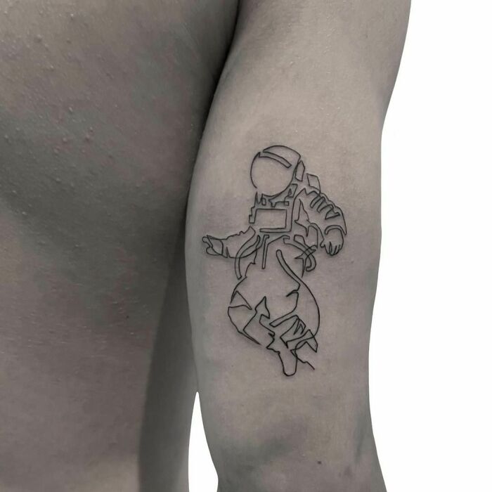 Line astronaut arm tattoo