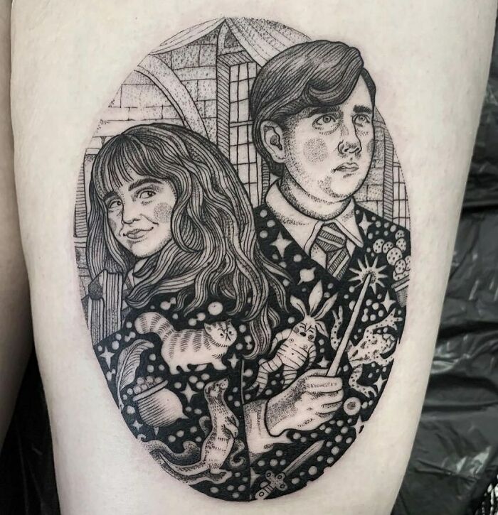Detailed Harry Potter tattoo featuring a witch and wizard in intricate patterns with magical elements.