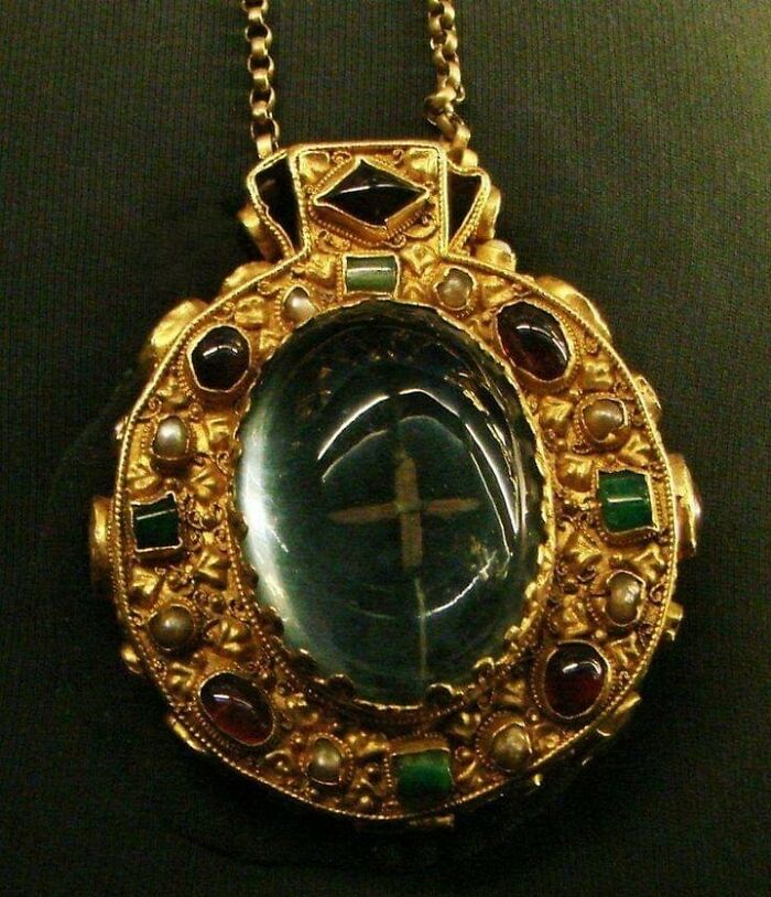 The Talisman Of Charlemagne, C. 768-814. Two Large Cabochon Sapphires - One Oval, One Square - Enclose Holy Relics (What Are Supposed To Be A Remnant Of The Holy Cross And A Small Piece Of The Virgin's Hair, Visible Only When Looking Through The Oval Sapphire At The Front Of The Medallion.) The Other Gemstones Are Garnets, Emeralds, And Pearls