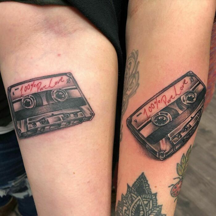 Matching cassette tape arm tattoos