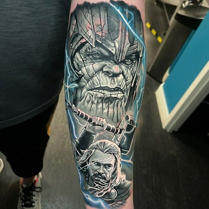 Marvel tattoo featuring detailed portraits of iconic characters Thanos And Thor on a forearm.