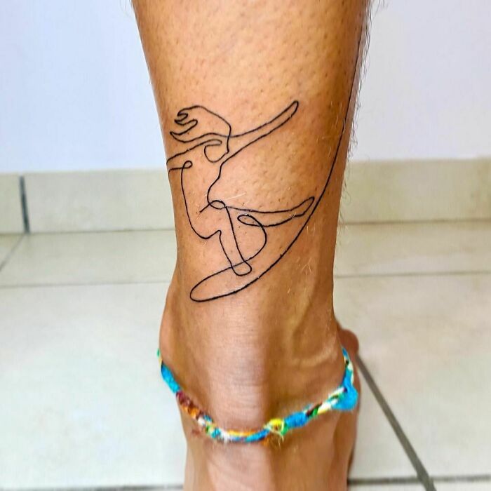 Single line surfer ankle tattoo