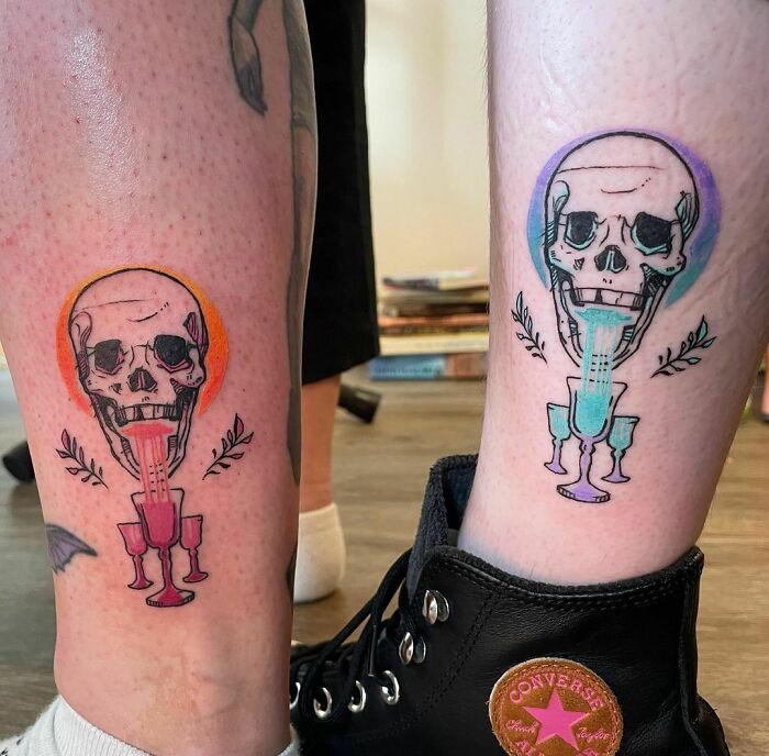 Matching colorful skull leg tattoos