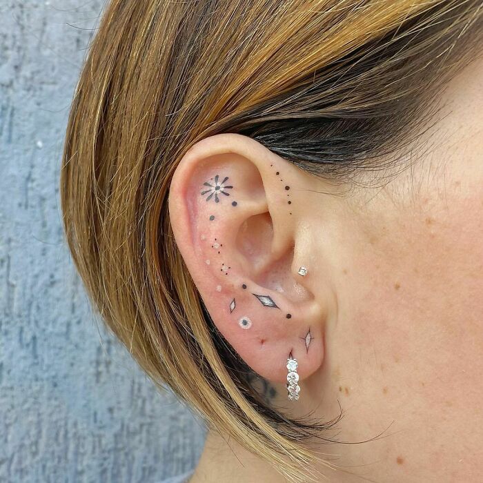 ear tattoo of ornamental black and white decorations