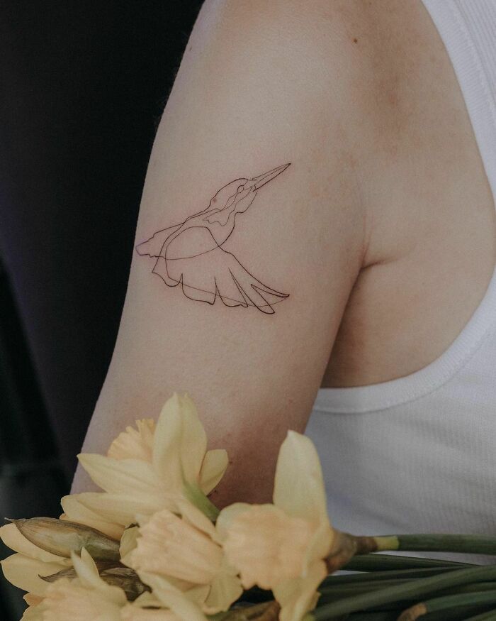 Single line swimming bird tricep tattoo