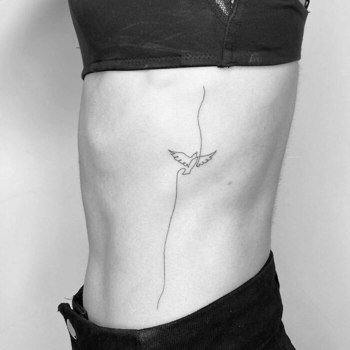 Single line flying bird tattoo
