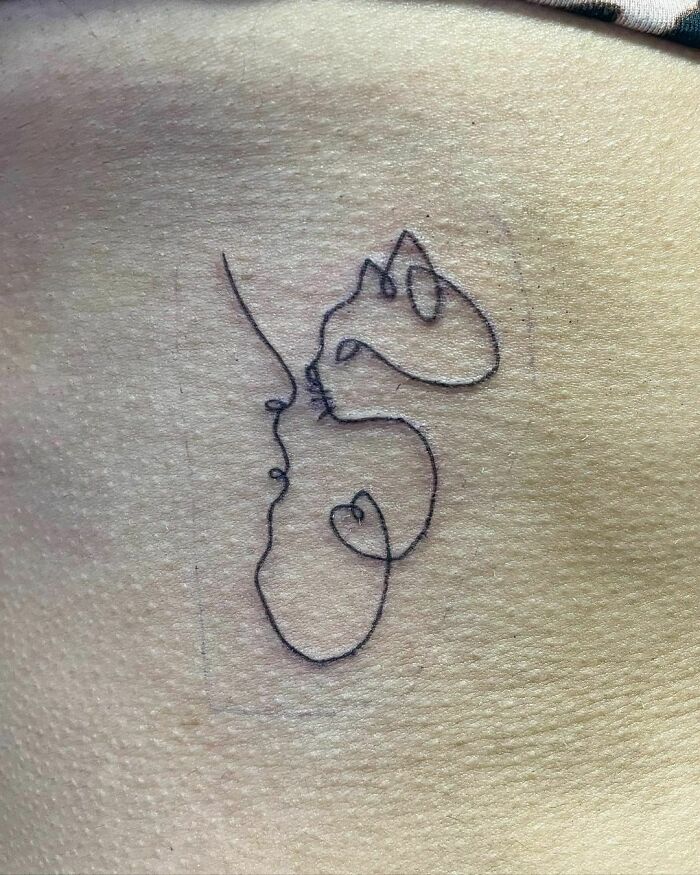 Single line cat face tattoo