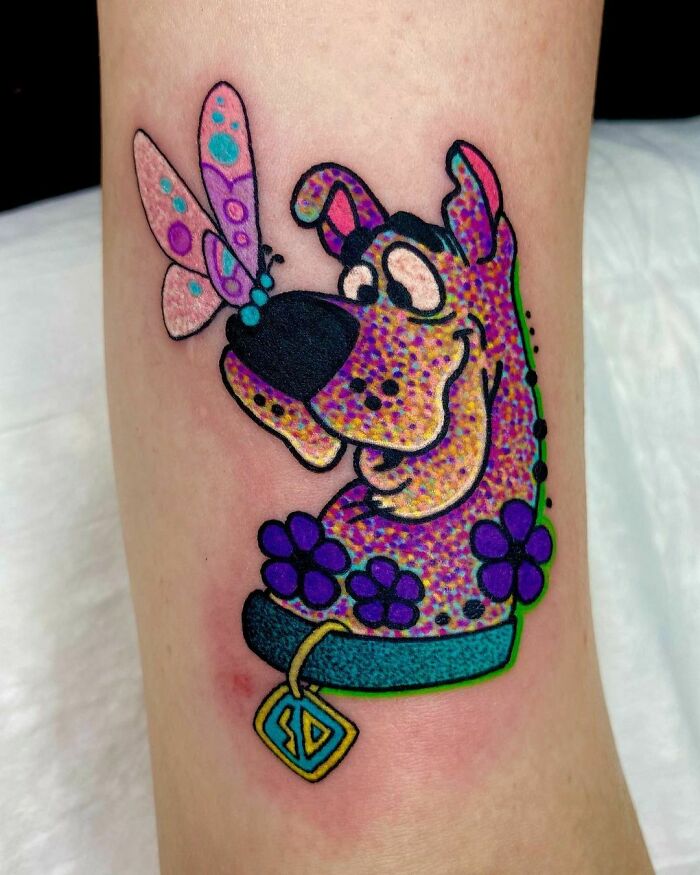 Scooby-Doo and butterfly on his nose tattoo 