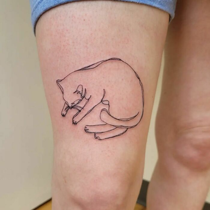 Line cat sleeping leg tattoo