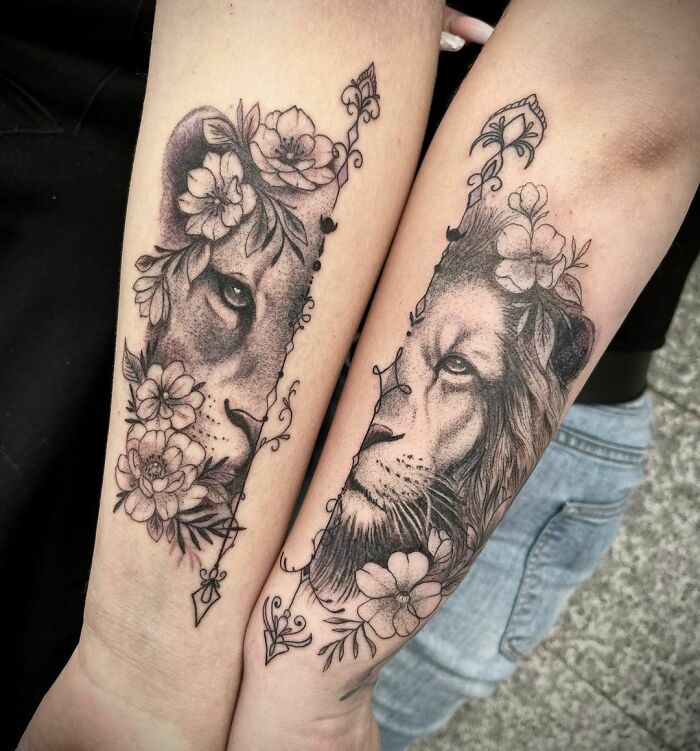 Lion and lioness heads with flowers forearm tatttoos
