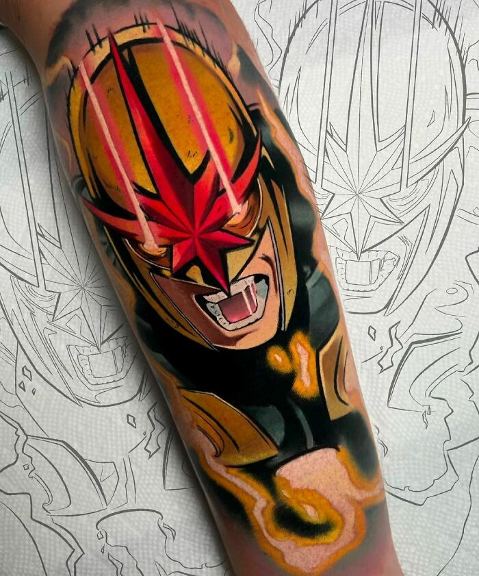 Colorful Marvel tattoo of X-Man superhero helmet on arm with dynamic background outlines.