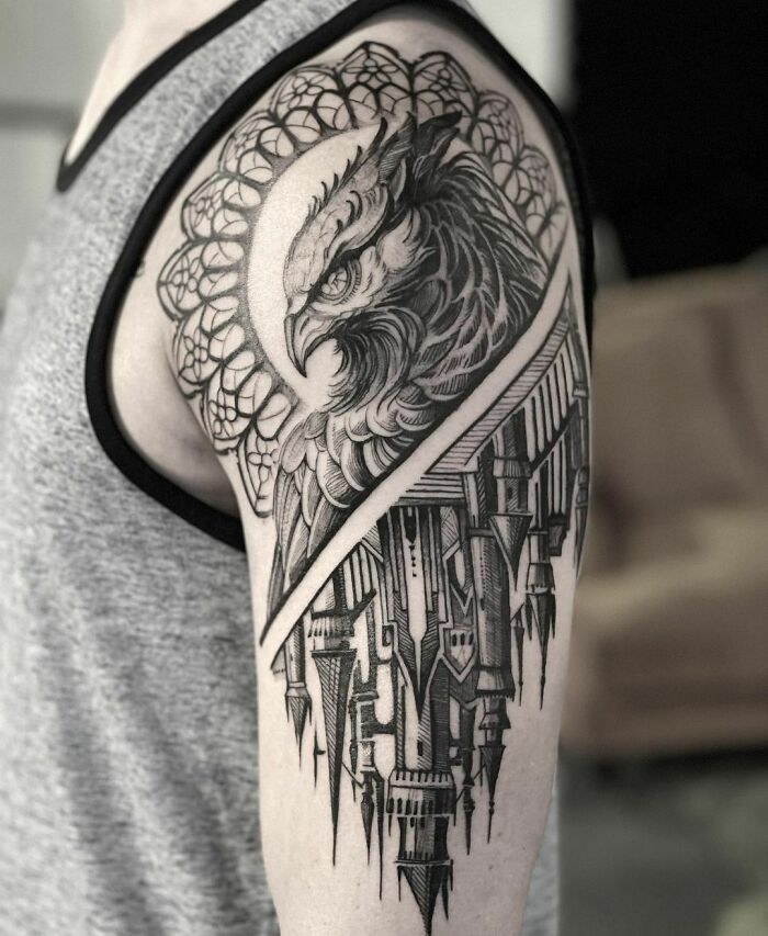 Black and gray owl tattoo with intricate geometric patterns and castle elements on upper arm, inspired by Harry Potter.