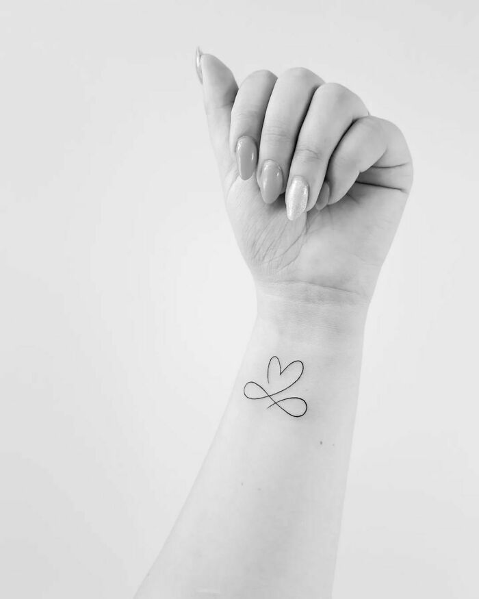 Line infinity heart arm tattoo