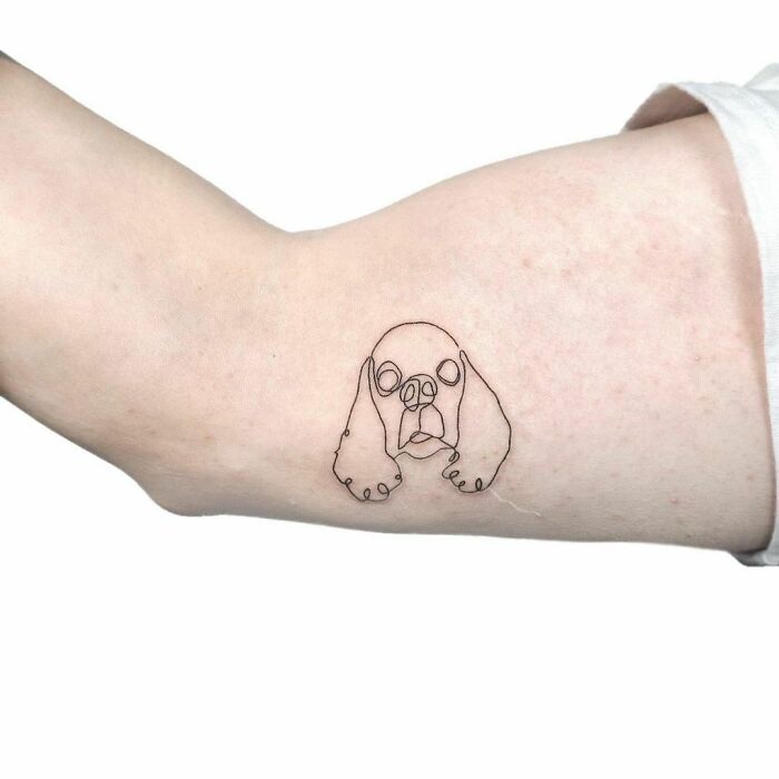 Single line dog arm tattoo