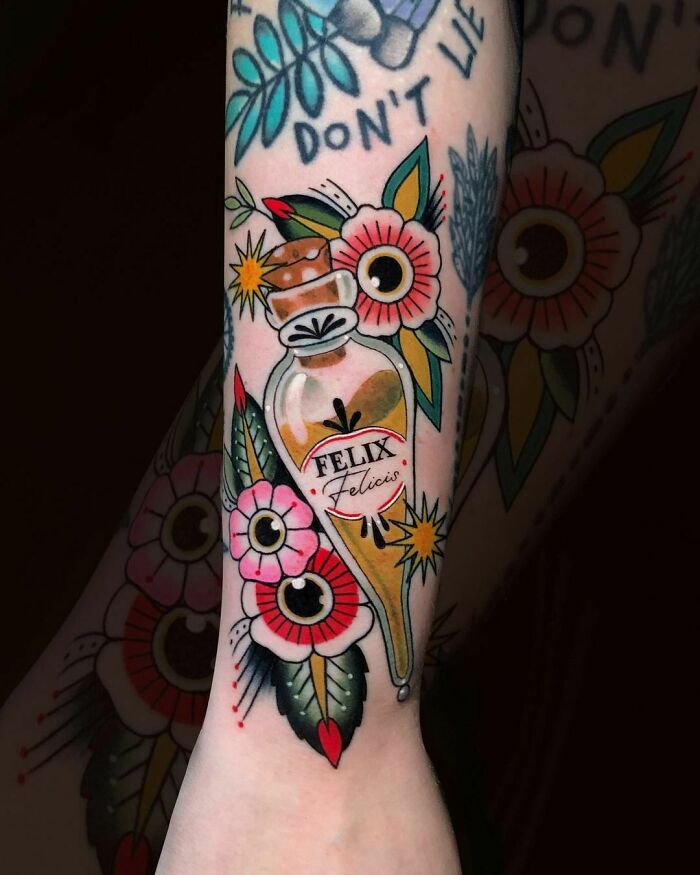 Felix Felicis tattoo with colorful flowers, perfect for Harry Potter fans.