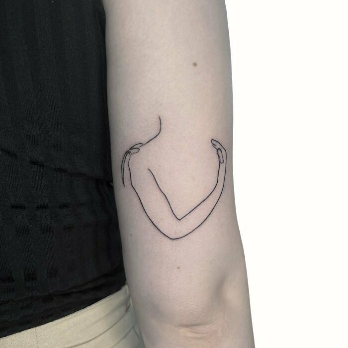 Single line hug arm tattoo