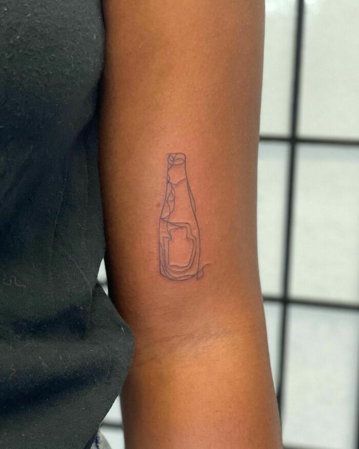 Single line minimalist ketchup bottle arm tattoo