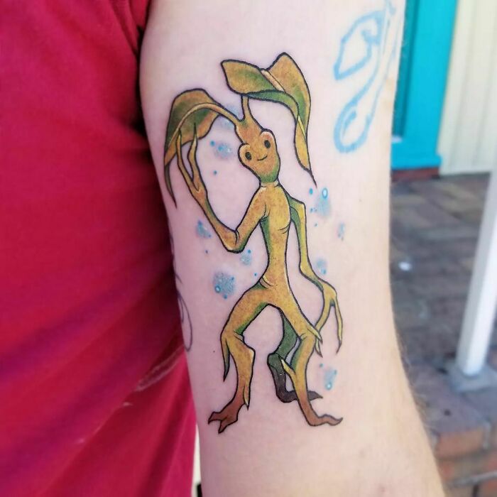 Harry Potter tattoo of a Bowtruckle creature on a person's arm, featuring detailed leaves and vibrant colors.
