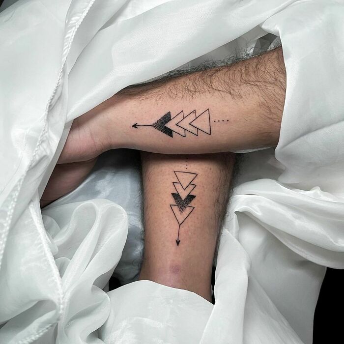 Triangles with arrows wrist tattoos