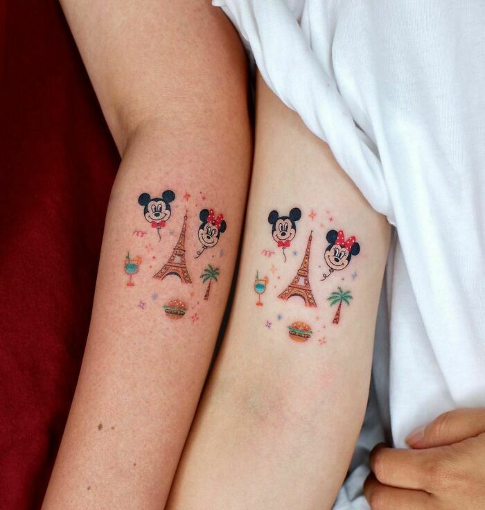Matching best friend tattoos featuring Mickey and Minnie, Eiffel Tower, palm trees, and tropical drinks.
