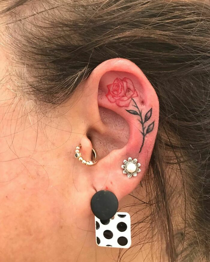 ear tattoo of a rose stalk