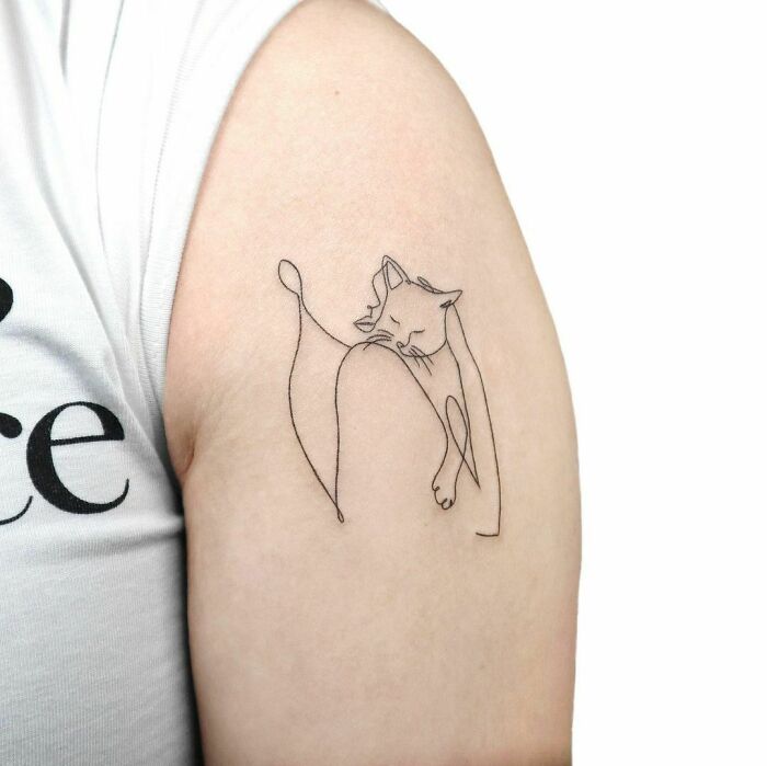 Single line woman holding a cat shoulder tattoo