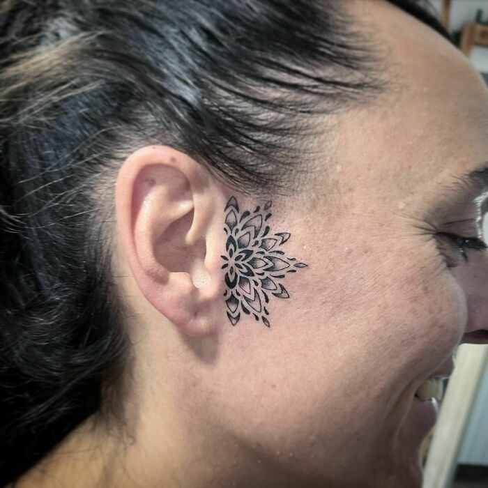 ear tattoo of an ornamental flower