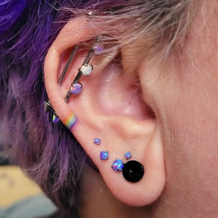 ear tattoo of a rainbow
